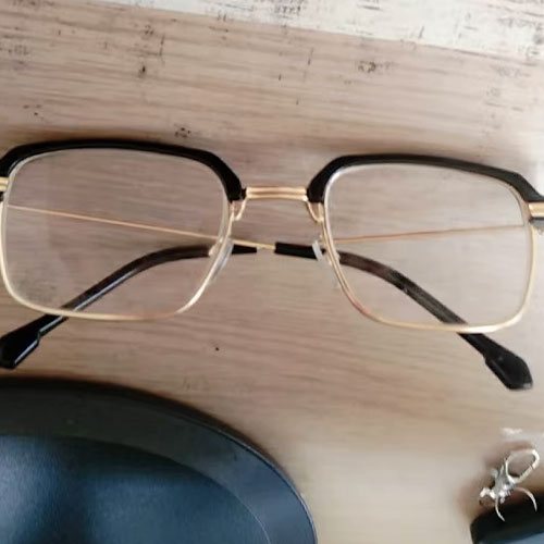 OptiReaders Pro glasses resting on a wooden table